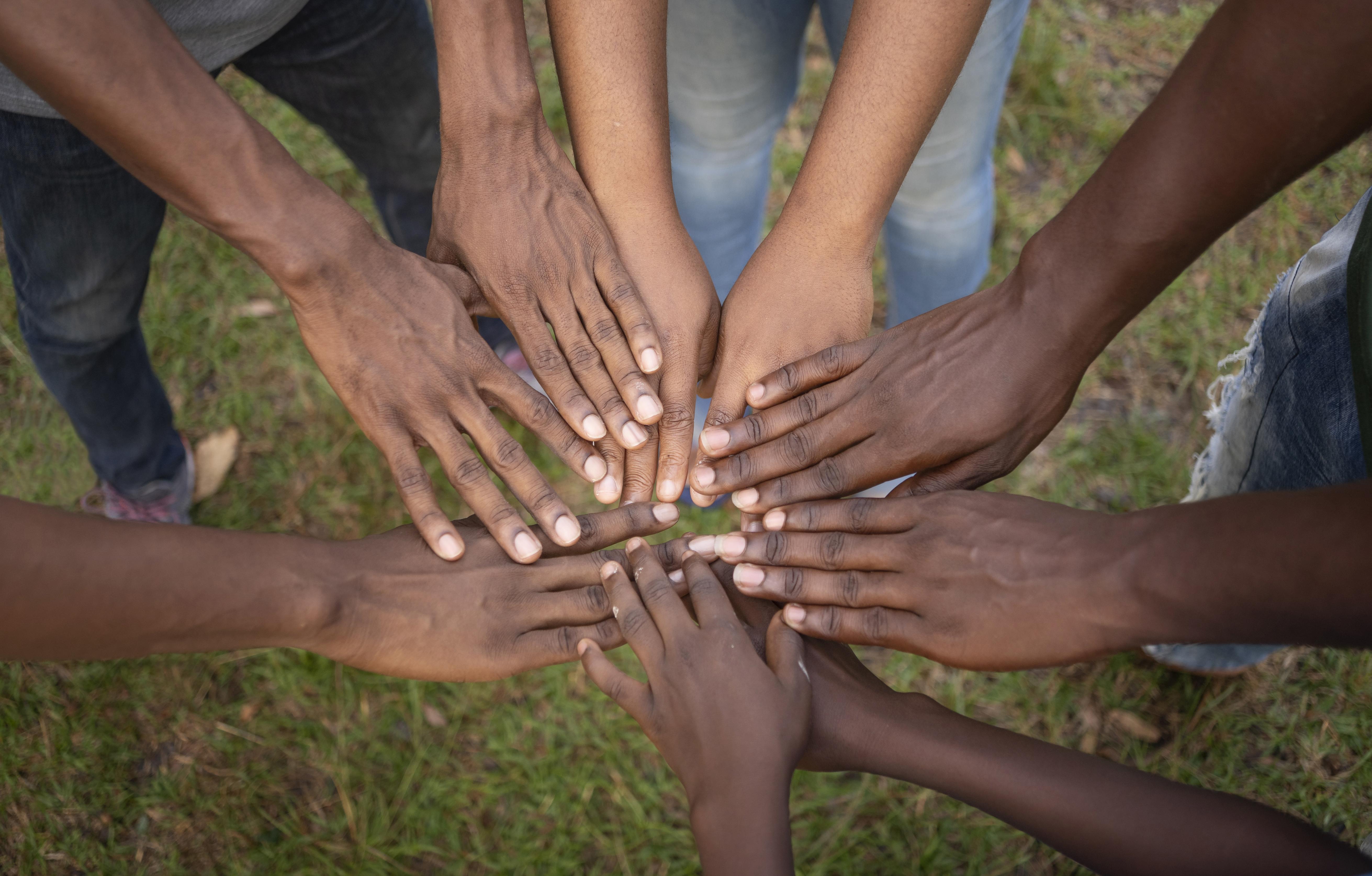 Diverse hands coming together in unity
